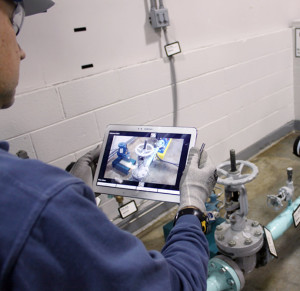 A plant technician uses the tablet technology to verify the completion of a valve alignment.