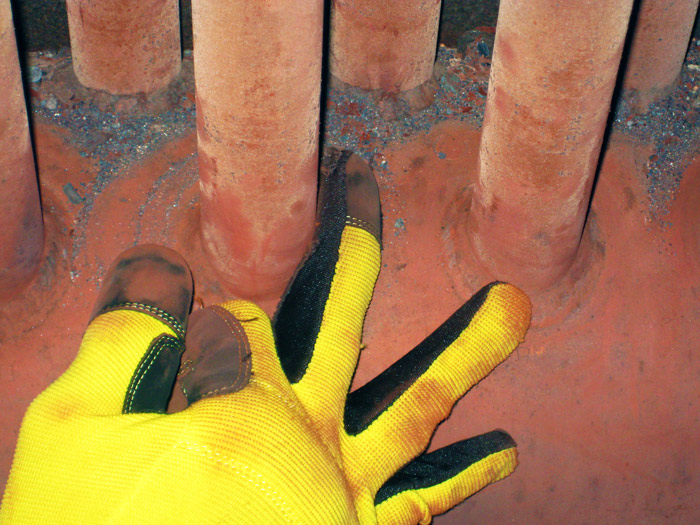A glove equipped with the flexible eddy current array probe is used to inspect tube-to-header welds in a heat recovery steam generator.