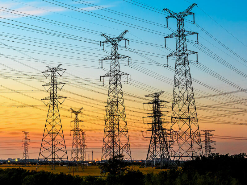 high-voltage power lines at sunset